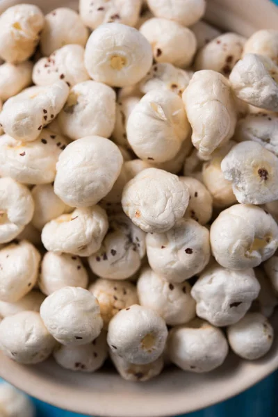 Makhana, also called as Lotus Seeds or Fox Nuts are popular dry snacks from India, served in a bowl. selective focus