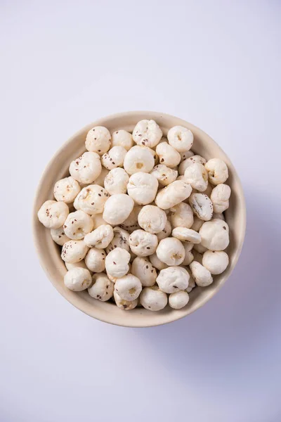 Makhana, also called as Lotus Seeds or Fox Nuts are popular dry snacks from India, served in a bowl. selective focus