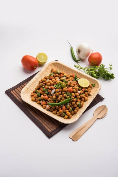 Black Chickpea Chaat or Kala Chana Chat recipe is a popular snack recipe from India, served in a bowl. selective focus