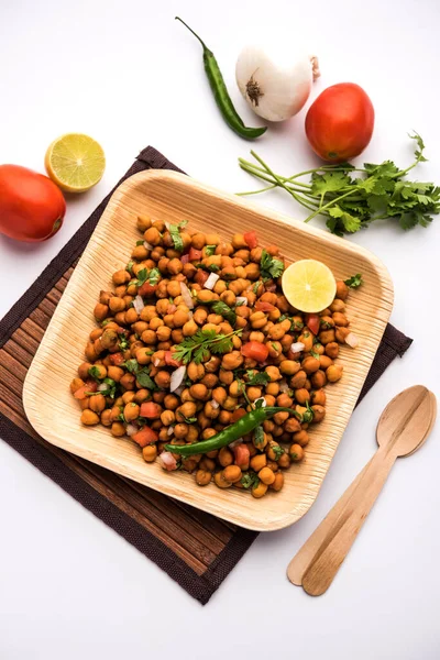 Black Chickpea Chaat or Kala Chana Chat recipe is a popular snack recipe from India, served in a bowl. selective focus