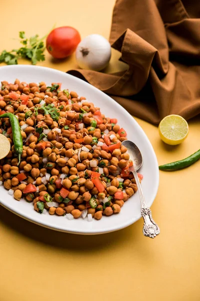 Black Chickpea Chaat or Kala Chana Chat recipe is a popular snack recipe from India, served in a bowl. selective focus