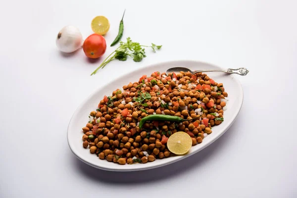 Black Chickpea Chaat or Kala Chana Chat recipe is a popular snack recipe from India, served in a bowl. selective focus