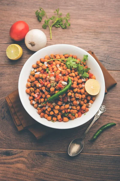 Black Chickpea Chaat or Kala Chana Chat recipe is a popular snack recipe from India, served in a bowl. selective focus