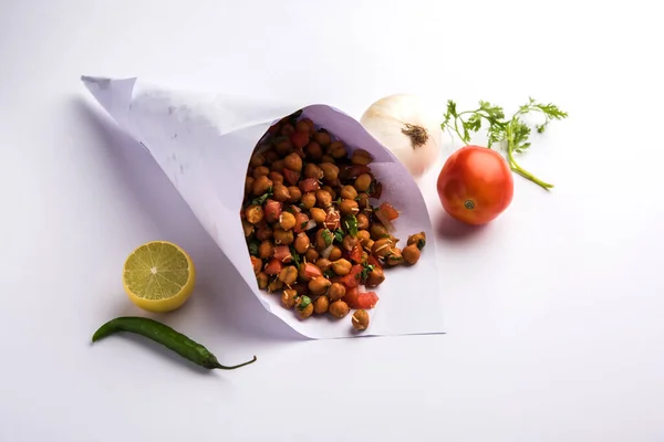 Black Chickpea Chaat or Kala Chana Chat recipe is a popular snack recipe from India, served in a bowl. selective focus