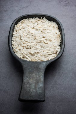 Çiğ pirinç ya da ince pirinç gevreği Namkeen Chivda atıştırmalıkları için ya da Hint kahvaltısı için Aloo Poha, bir kase içinde servis edilir.