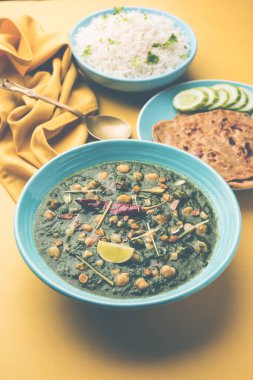 Nohut aromalı ıspanak körisi ya da Palak 'lı Chana Masala pilav ve düz ekmek ya da Paratha ile servis edilir.