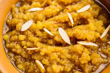 Moong dal halwa is a classic Indian sweet dish made with moong lentils, sugar, ghee and cardamom powder clipart