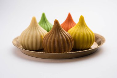 Modak is an Indian sweet dumpling offered to Lord Ganapati on Ganesh Chaturthi Festival. Served in a plate. Selective focus clipart