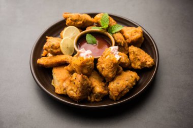 Chicken Pakora or pakoda or fritters is a popular Indian snack in which boneless chicken pieces are marinated and then coated with a mixture of besan, rice flour, cornflour, and egg clipart