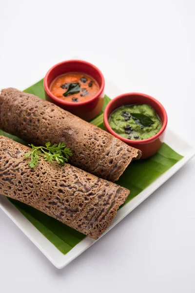 Finger Millet or Ragi Dosa is a healthy Indian breakfast served with chutney, in roll, flat or cone shape