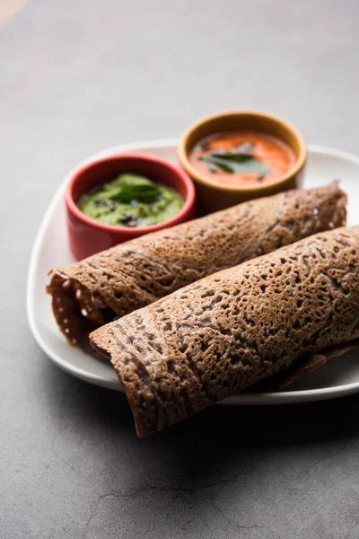 Finger Millet or Ragi Dosa is a healthy Indian breakfast served with chutney, in roll, flat or cone shape