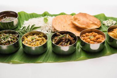 Traditional South Indian Meal or food served on big banana leaf, Food platter or complete thali.  selective focus clipart