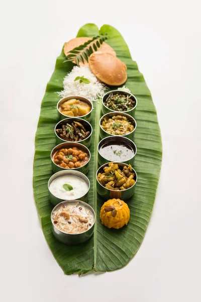 Traditional South Indian Meal or food served on big banana leaf, Food platter or complete thali.  selective focus