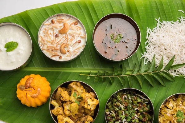 Traditional South Indian Meal or food served on big banana leaf, Food platter or complete thali.  selective focus