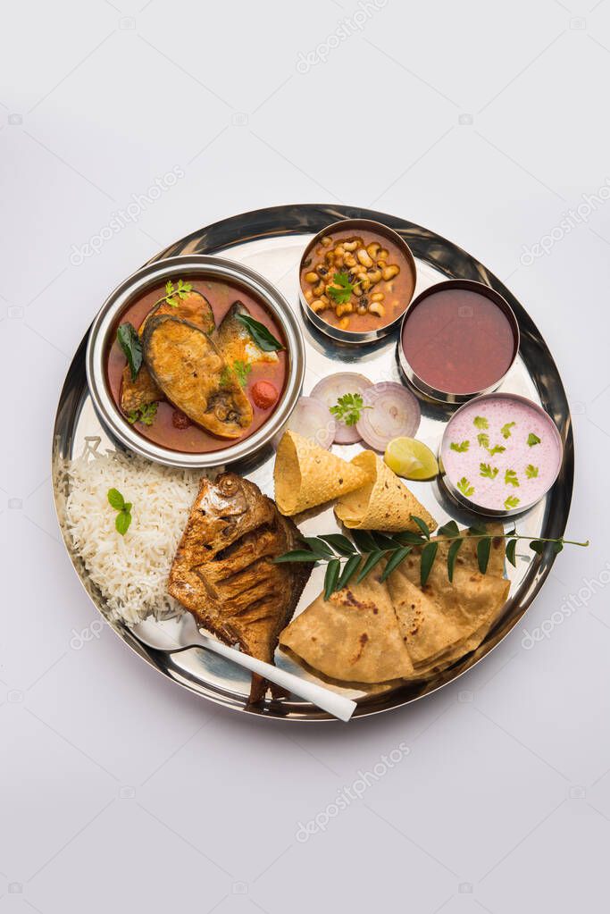 Indian Fish Platter or thali - Popular sea food, Non vegetarian meal from Mumbai, Konkan, Maharashtra, Goa, Bengal, Kerala served in a steel plate or over banana leaf
