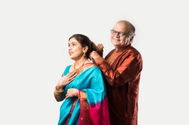 Hintli yaşlı adam doğum gününde, sevgililer gününde, yıldönümünde ya da Diwali festivalinde güzel karısına altın kolye takıyor ya da sunuyor.