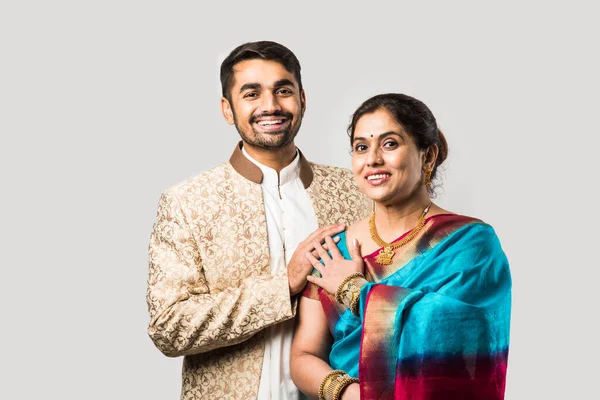 Indian asian old Mother and adult son in traditional wear, standing isolated over white background