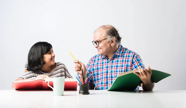 Indian Grandfather Teaching Granddaughter Books Pencil Laptop Home Schooling Tuition — Stock Photo, Image