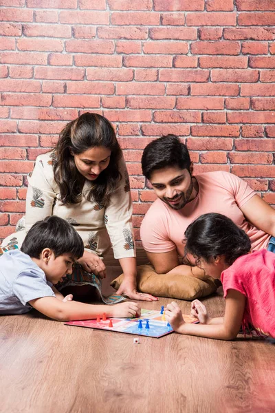 Indian Young Family Four Playing Board Games Chess Ludo Snack — Stock Photo, Image