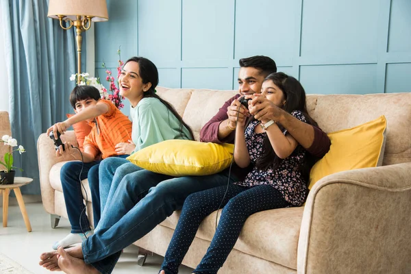 Indian Young Family Four Playing Video Game Using Controller Joystick — Stock Photo, Image