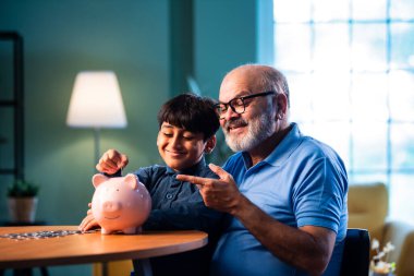 Hintli büyükbaba çocuklara evde kumbarada para biriktirmeyi öğretiyor, yaşlı adam torununa mali disiplin konusunda rehberlik ediyor, iyi para alışkanlığını güvence altına alıyor, aile bağlarını güvence altına alıyor.