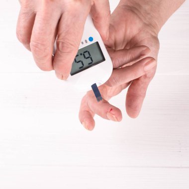 Diyabet, kol close-up ve bir damla kan şeker testi