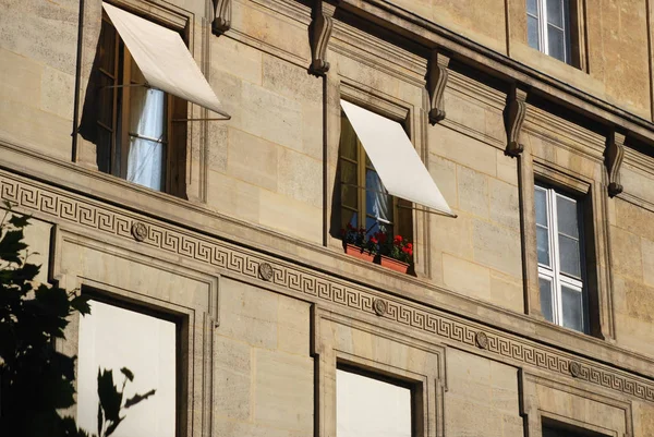 The awnings cover the windows of the apartments, protecting them from the sun. France. Paris.