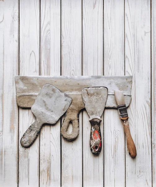 Spatulas with the remaining mortar. Gastarbeiter or guest worker