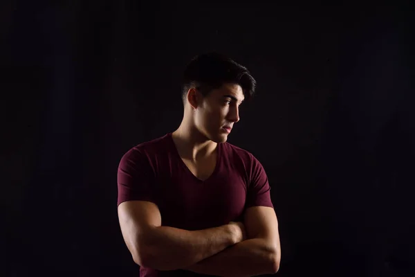 portrait of a young man on black background