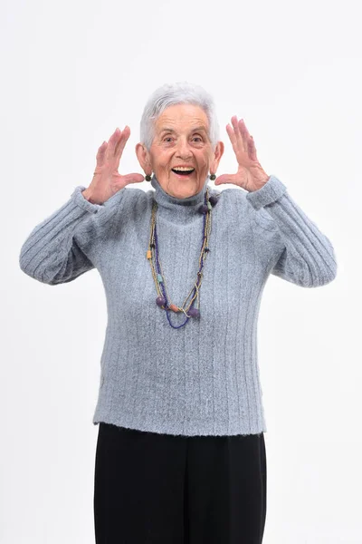 Senior woman with expression of forgetfulness or surprise on whi — Stock Photo, Image