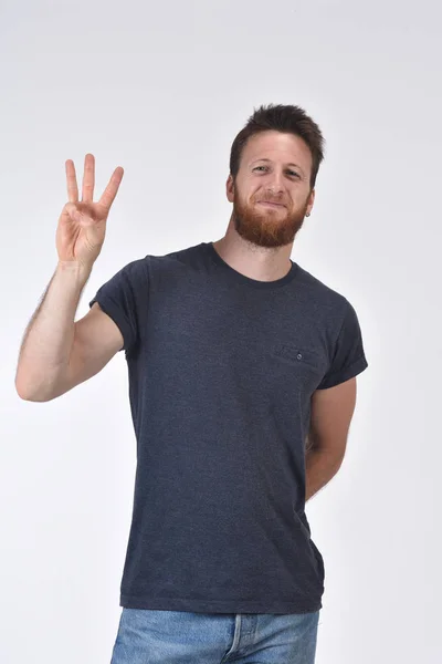 Homem com o dedo em forma de número três — Fotografia de Stock