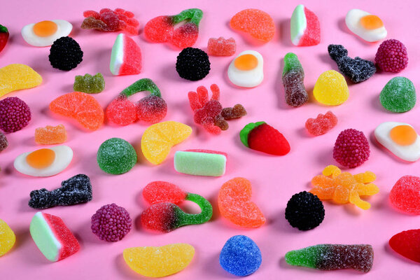 group of gummy candies on pink background