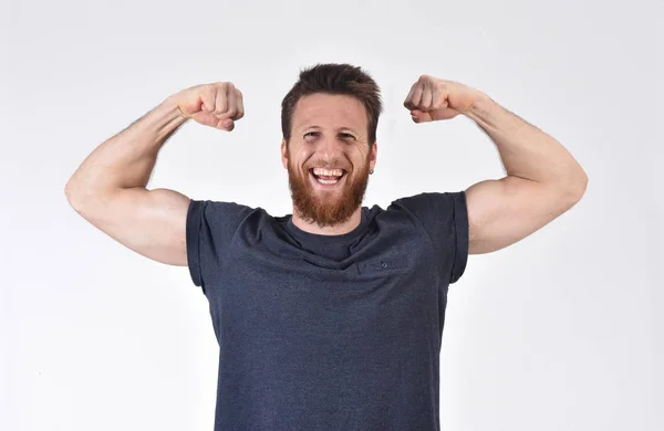 L'uomo alza le braccia facendo bicipiti e segno di vittoria e stren — Foto Stock