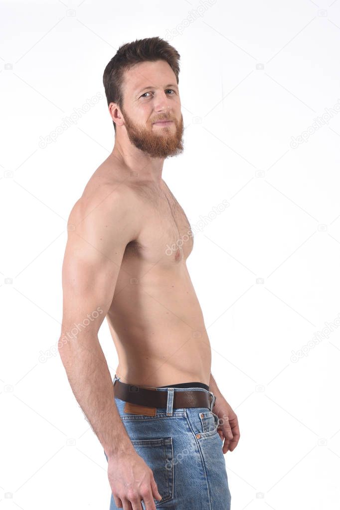 man shirtless and with blue jeans on white background
