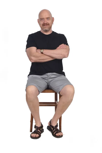 Bald Man Sandals Shirt Shorts Sitting White Background Arms Crossed — Stock Photo, Image