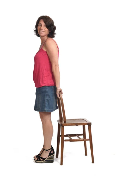 Mujer Falda Mezclilla Jugando Con Una Silla Sobre Fondo Blanco — Foto de Stock