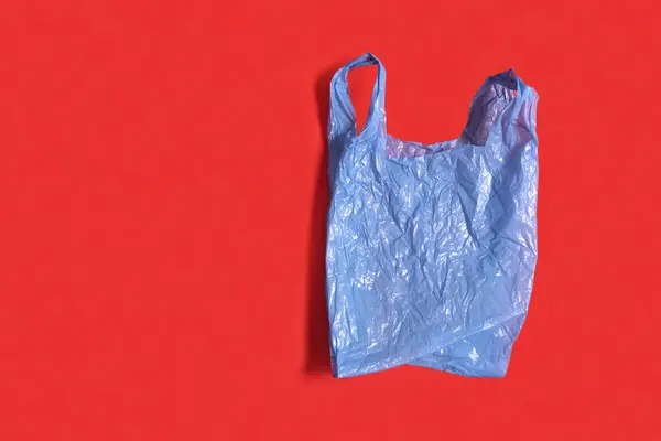 Blue Plastic Bag Red Background — Stock Photo, Image