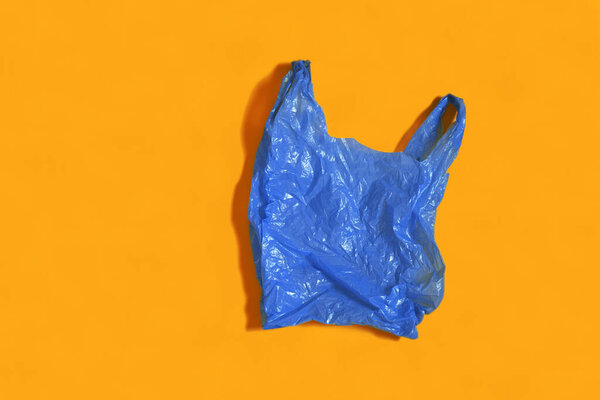 blue plastic bag on orange background
