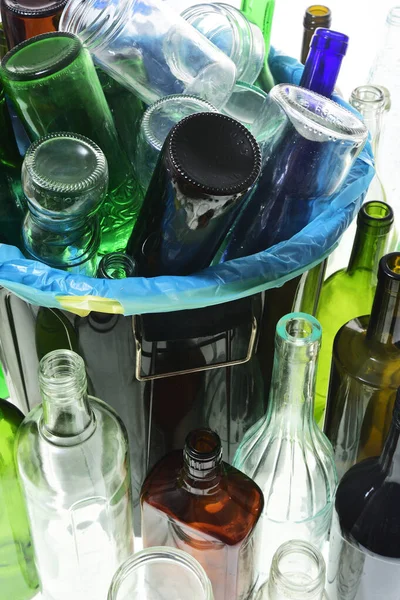 garbage can with bottles for recycling on white background