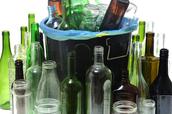 garbage can with bottles for recycling on white background