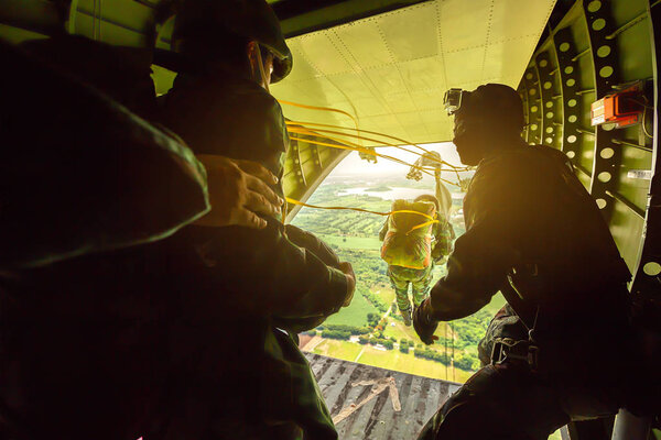 Rangers parachuted from military airplanes, Soldiers parachuted from the plane, isolated airborne soldier, practice parachuting, Paratroopers jumping from an airplane.