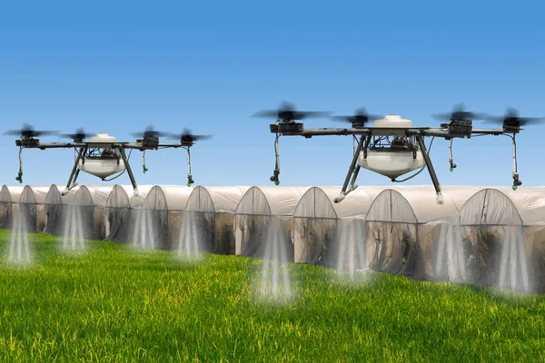 Agriculture drone flying over Hydroponic organic fresh vegetable garden farm at greenhouse against blue sky with rice fields.