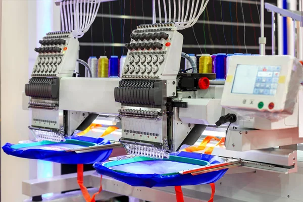 Textile - Professional and industrial embroidery machine. Machine embroidery is an embroidery process whereby a sewing machine or embroidery machine is used to create patterns on textiles.