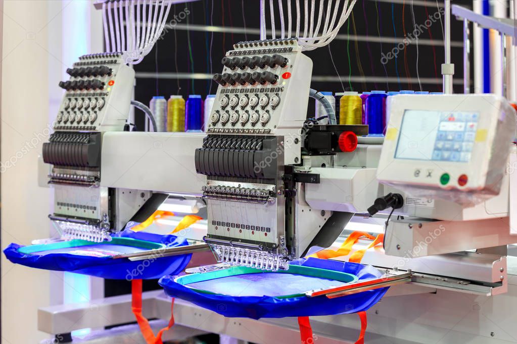 Textile - Professional and industrial embroidery machine. Machine embroidery is an embroidery process whereby a sewing machine or embroidery machine is used to create patterns on textiles.