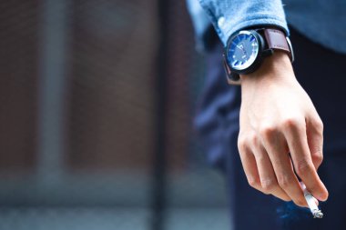 Adam el üzerinde sokak küllük, sigara izmariti, Sigara Sigara söndürme ölüyor. Sigarayı bıraktım. Sağlık kavramı. 