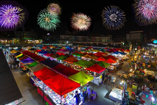 Bird eyes view of Multi-colored tents /Sales of second-hand market with new year firework at night.