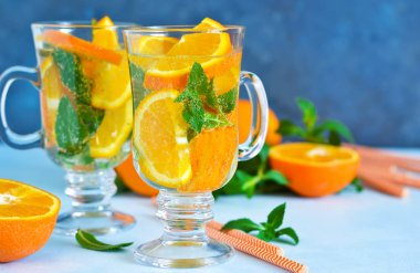 Soğuk yaz içeceği. Nane ve mavi bir arka plan üzerinde turuncu ile limonata.