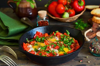 Shakshuka İsrail mutfağının geleneksel bir kahvaltıdır. Domates soslu biber, soğan ve baharatlar ile yumurta kızarmış.