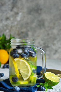 Limonata limon, limon ve yaban mersini bir taş zemin üzerine. Yaz soğuk içecek.