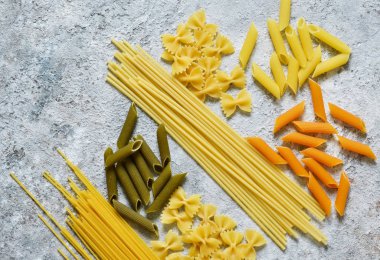 Makarna bir beton zemin üzerine çeşitli. Yemek pişirmek için ham Yapıştır. İtalyan Makarna.